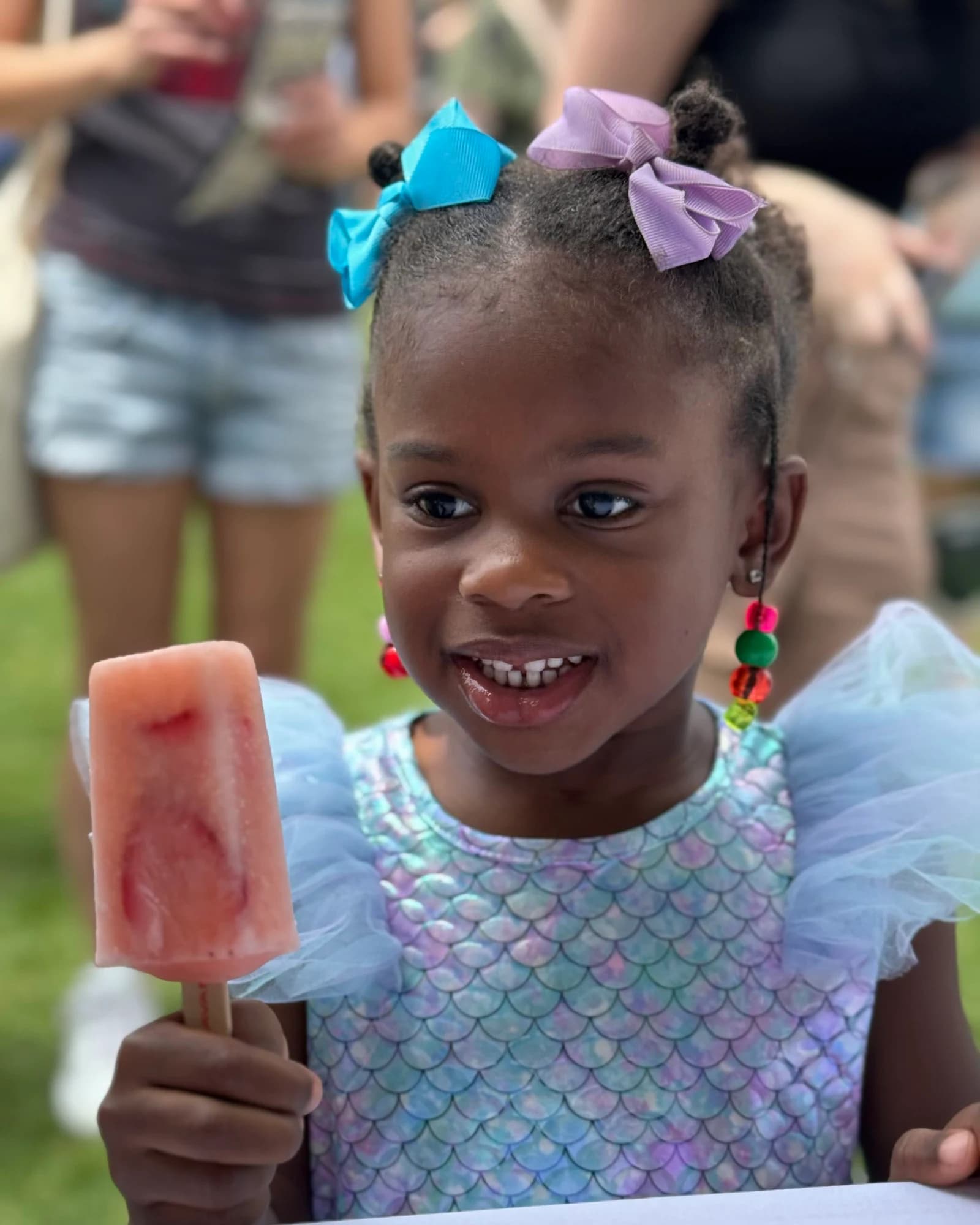 A girl enjoying a Savannah Square Pops pop at an outdoor event