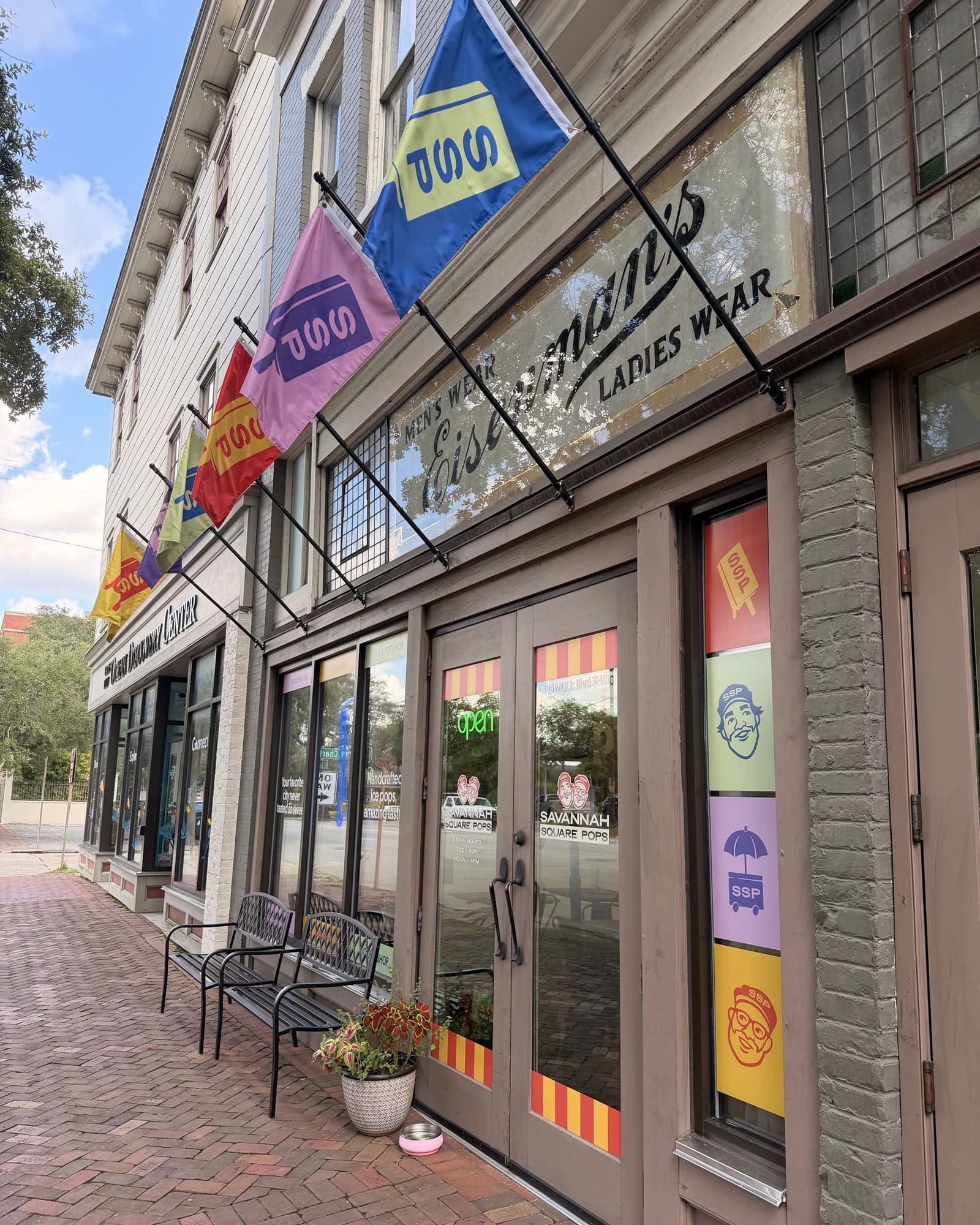 Front of the Savannah Square Pops shop with colorful sidewalk flags