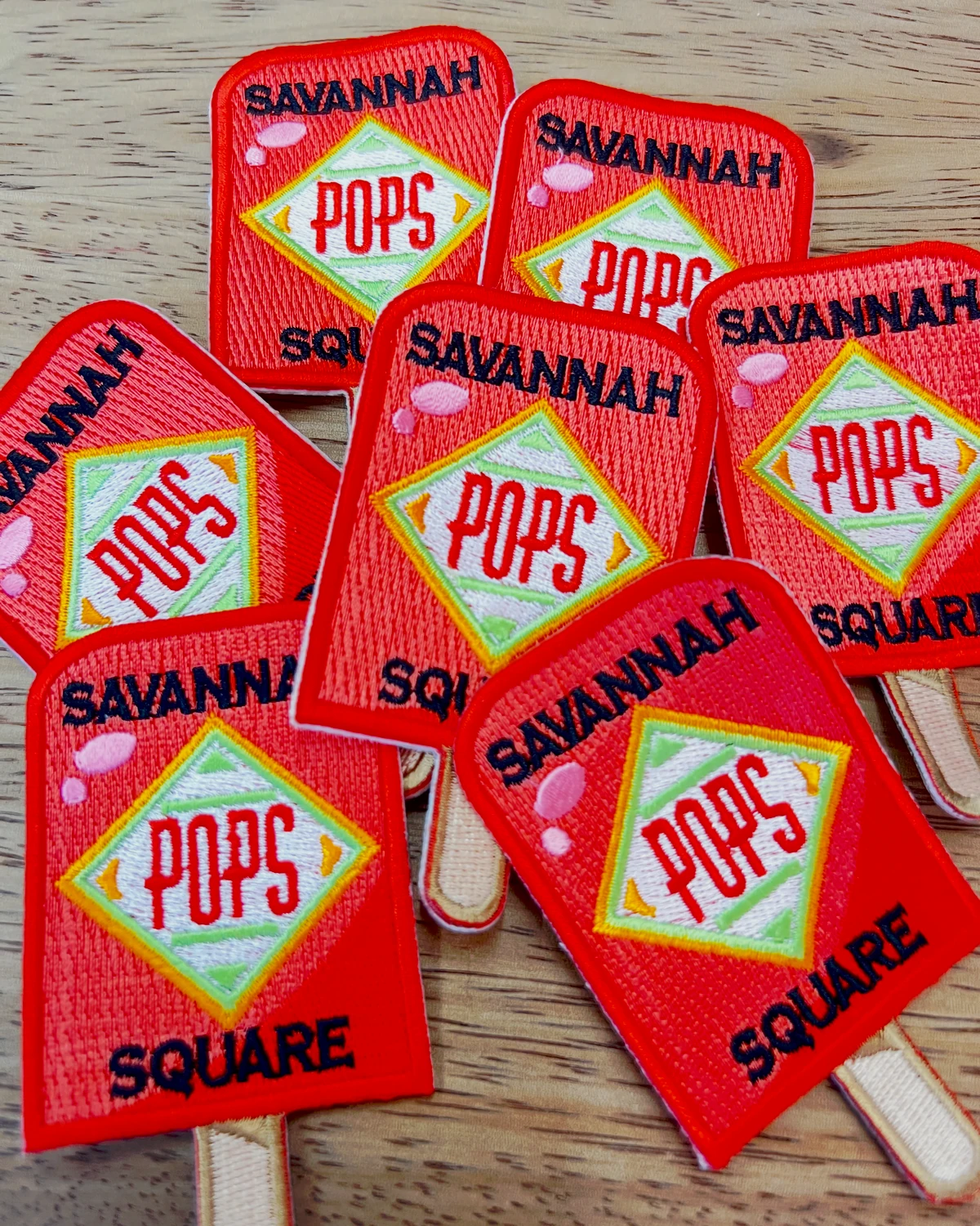 Savannah Square Pops commemorative pop-shaped patches arranged on a table